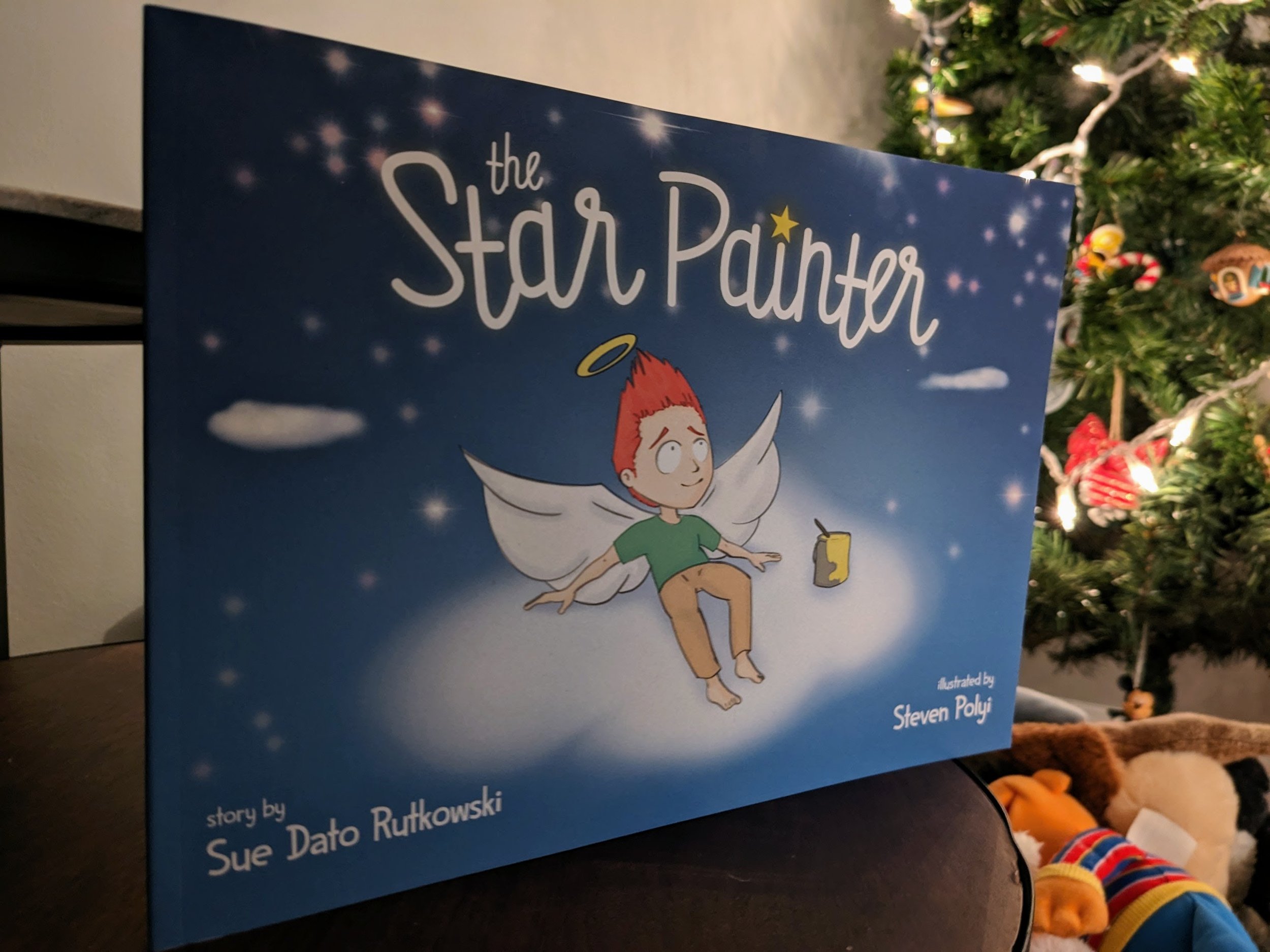 The Star Painter book cover — illustrated children's book showing a young angel painting stars